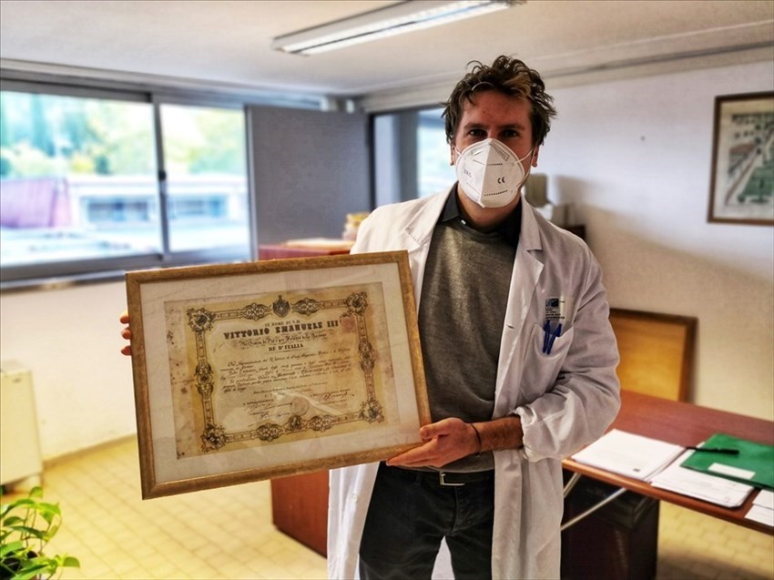 il direttore sanitario mostra il  diploma di Palagi